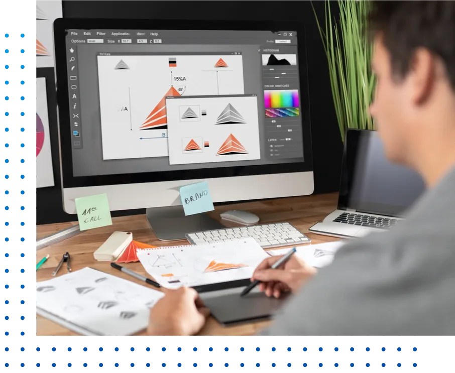 Graphic designer crafting brand assets at a workstation